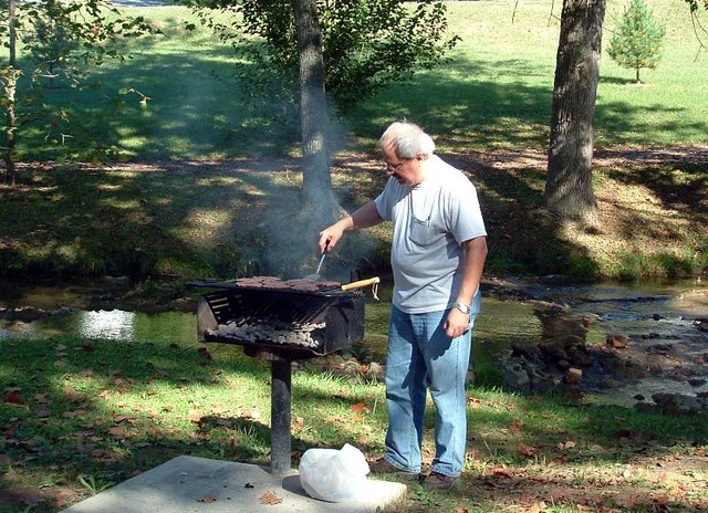 Head Chef, Carl Bailey prepares wonderful hamburgers and hot dogs for the meal.
