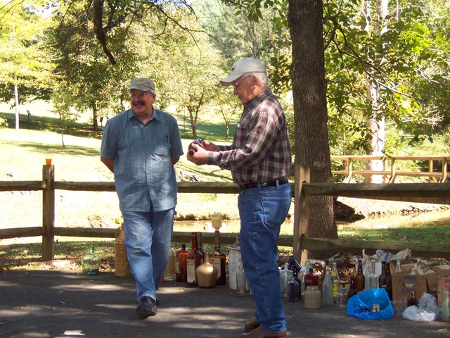 Carl Bailey & Wade Cox inspecting auction items-2010 picnic.